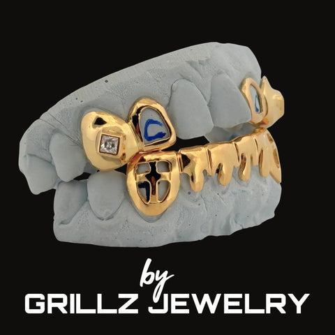 Gold grillz on a gray skull with 'GRILLZ JEWELRY' branding.
