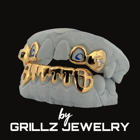 Grillz jewelry with gold and blue accents on a black background, branded by Grillz Jewelry.