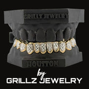 Grillz jewelry set on a black stand with 'Grillz Jewelry' branding.
