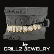 Grillz jewelry display with gold and diamond-encrusted grill on a black background, featuring the brand 'Grillz Jewelry'.