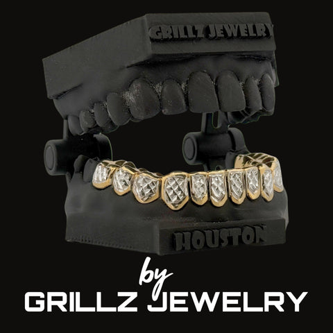 Black grill with gold and diamond accents on a black background, branded as Grillz Jewelry.