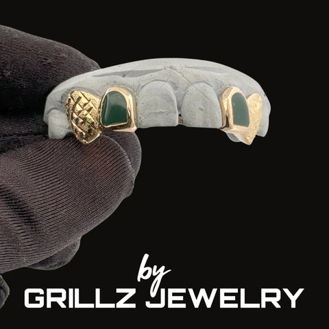 Grillz jewelry with gold and green accents on a black background, featuring the brand 'GRILLZ JEWELRY'.