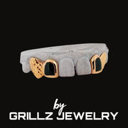 Grill with concrete and gold accents on a black background, branded by Grillz Jewelry.