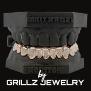Grillz jewelry set on a black stand with 'Houston by Grillz Jewelry' branding.