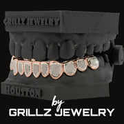 Grillz jewelry set on a black stand with 'Grillz Jewelry' branding.