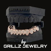 Rose gold grillz on a black stand with 'Grillz Jewelry' branding.
