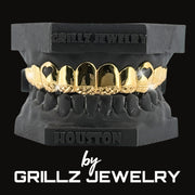 Diamond-studded grillz in a black case with 'Grillz Jewelry' branding on a black background.