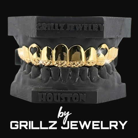 Diamond-studded grillz in a black case with 'Grillz Jewelry' branding on a black background.