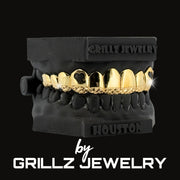 Black and gold grillz jewelry set on a black background with 'Grillz Jewelry' branding.