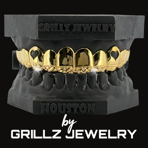 Diamond-studded grillz held by a gloved hand with 'Grillz Jewelry' branding.