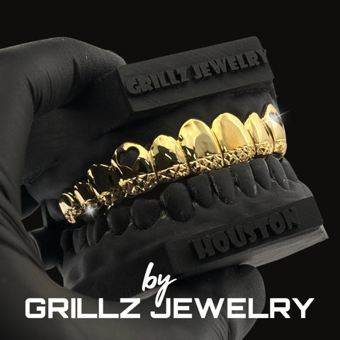 Diamond-studded grillz on a black stand with 'Grillz Jewelry' branding.