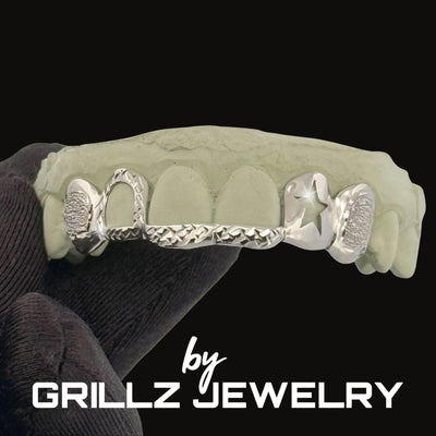 Gold grill on a black stand with 'Grillz Jewelry' branding.
