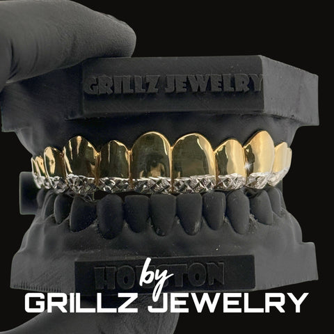 Silver grillz jewelry held by a gloved hand with 'Grillz Jewelry' branding.