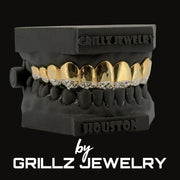 Black and gold grillz jewelry set with 'Grillz Jewelry' branding on a black background.