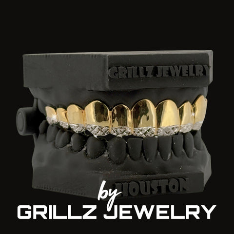 Black grill with gold and diamond accents on a black background, featuring 'Grillz Jewelry' branding.