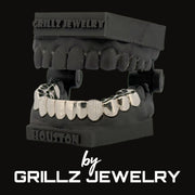 Silver grill on a black jaw model with 'Grillz Jewelry' branding.