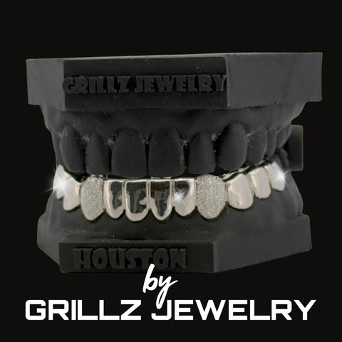 Black grill with silver teeth on a black background, branded as Grillz Jewelry.