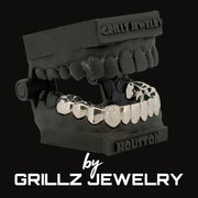 Silver grillz on a black stand with 'Grillz Jewelry' branding.