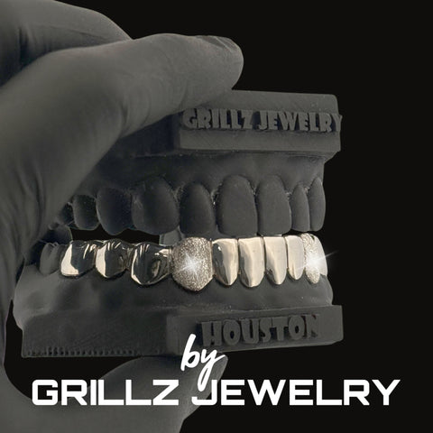 Grillz jewelry set held by a gloved hand with 'Grillz Jewelry' branding.