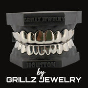 Silver grillz on a black stand with 'Grillz Jewelry' branding.