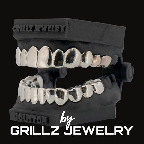 Silver grillz jewelry set on a black background with 'Grillz Jewelry' branding.