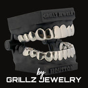 Silver grillz jewelry set with black case on a white background, featuring 'Grillz Jewelry' branding.