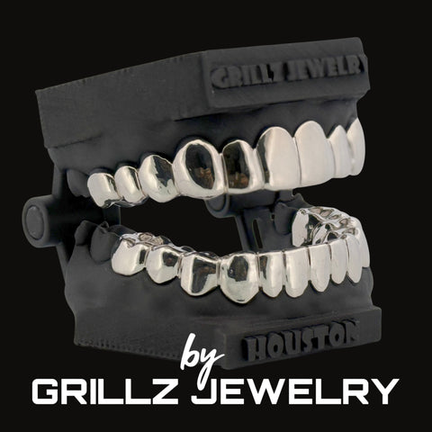 Silver grillz jewelry set with black case on a white background, featuring 'Grillz Jewelry' branding.