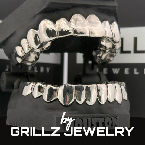 Silver grillz on a stand with 'Grillz Jewelry' branding in the background