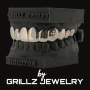Silver grillz on a black stand with 'Grillz Jewelry' branding.
