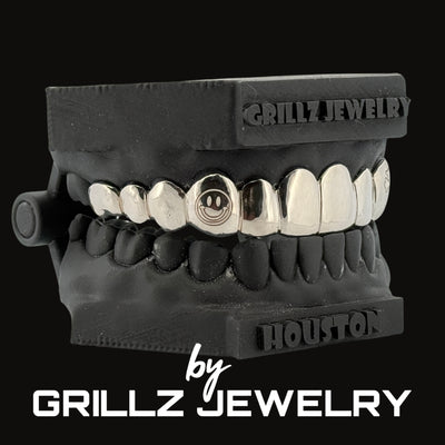 Black grillz jewelry set with 'Grillz Jewelry' branding on a black background