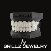 Grillz jewelry set on a black stand with 'Grillz Jewelry' branding.