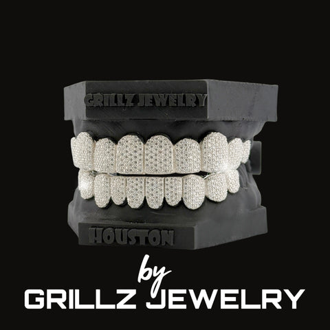 Grillz jewelry set on a black stand with 'Grillz Jewelry' branding.