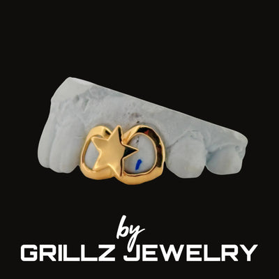 Gold grill with star design on a white surface, branded as Grillz Jewelry.