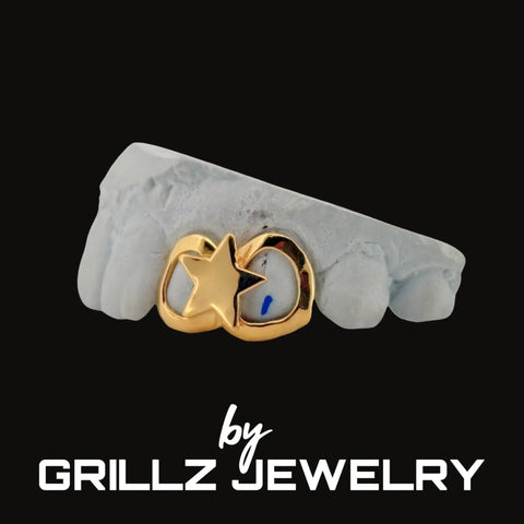 Gold grill with star design on a white surface, branded by Grillz Jewelry.