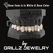 Grillz jewelry set on a black stand with 'Houston' branding, displayed by Grillz Jewelry.