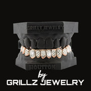 Grillz jewelry set on a black stand with 'Grillz Jewelry' branding.