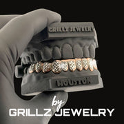 Grillz jewelry set held by a gloved hand with 'Grillz Jewelry' branding.