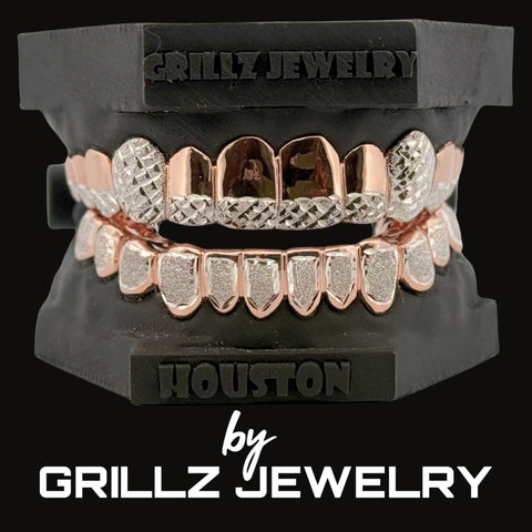 Rose gold and silver grillz on a black stand with 'Grillz Jewelry' branding.