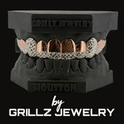 Grillz jewelry set on a black stand with 'Grillz Jewelry' branding.