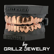 Rose gold grillz on a black stand with 'Grillz Jewelry' branding.