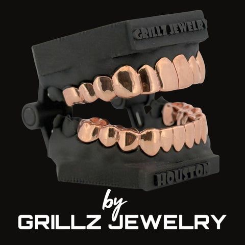Rose gold grillz on black case with 'Grillz Jewelry' branding on a black background