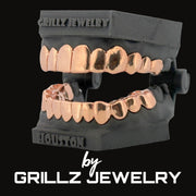 Rose gold grillz on black mannequin mouth with 'Grillz Jewelry' branding.