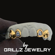 Grillz jewelry with gold accents on a black background, featuring the brand 'GRILLZ JEWELRY'.