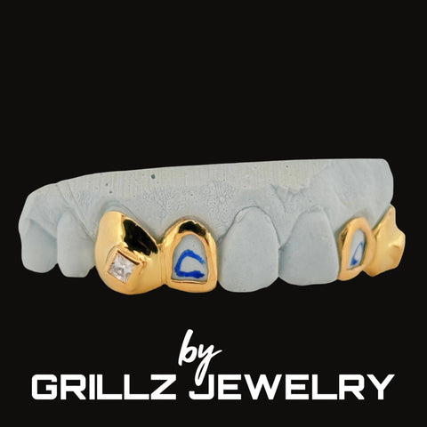 Gray and gold grillz with blue accents on a black background, branded as Grillz Jewelry.