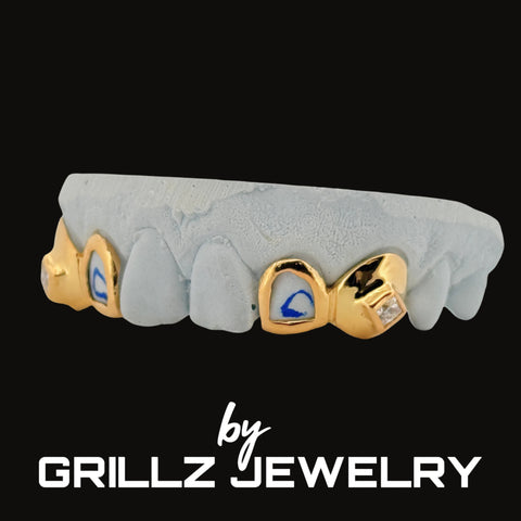 Gold and gray grill with gemstones on a black background, branded as Grillz Jewelry.