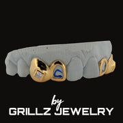 Gold grillz with blue and clear gemstones on a gray background, branded by Grillz Jewelry.