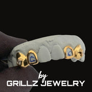 Grillz jewelry with gold and blue accents on a black background, featuring the brand 'Grillz Jewelry'.