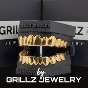 Gold grillz on a black stand with 'Grillz Jewelry' branding in the background.